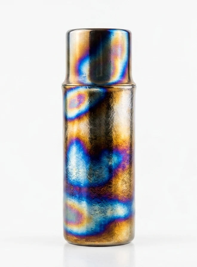 Hand-fired titanium cup presented as an art object